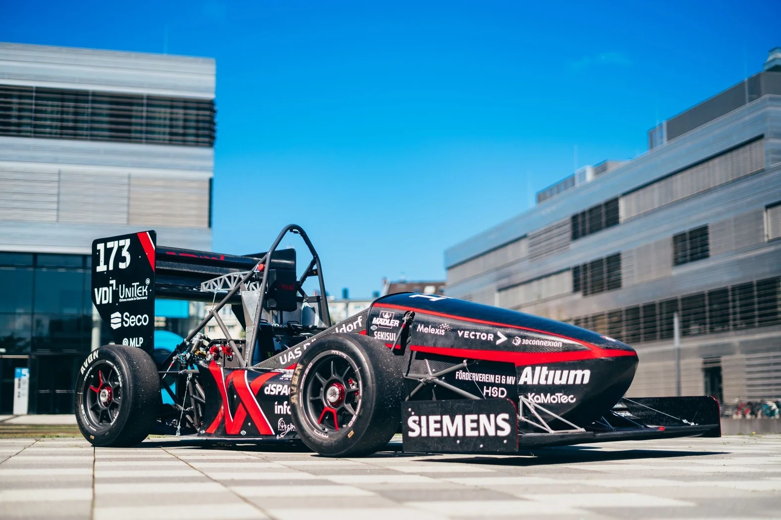 E-Traxx electric race car parked on campus